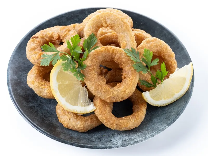 Crispy battered onion rings with lemon at Pier One Fish & Chips, a Fish & Chips Restaurant in Montebello