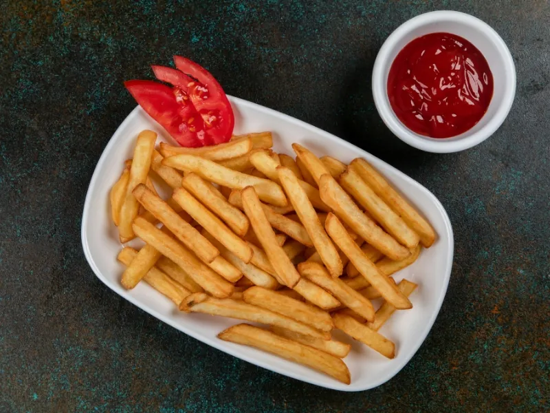 Golden French fries served with ketchup at Pier One Fish & Chips, a Fish & Chips Restaurant in Montebello